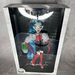 monster high doll with blue hair, red and white outfit